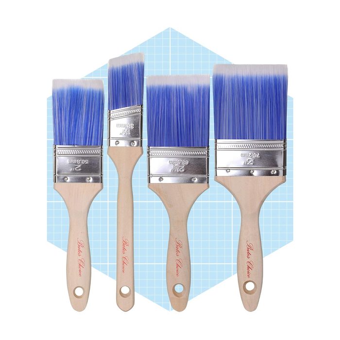 Four paintbrushes with blue bristles are arranged side by side against a light blue geometric background, ready for use in painting tasks.