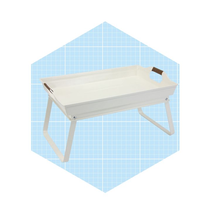 A white tray with raised edges sits on folding metal legs, designed for carrying items. The background features a blue grid pattern.