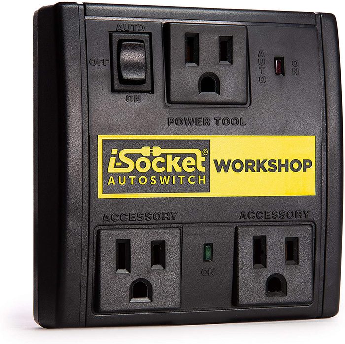 A black power strip features two outlets, switches, and an indicator light, designed for automatic power control in workshops or home settings.