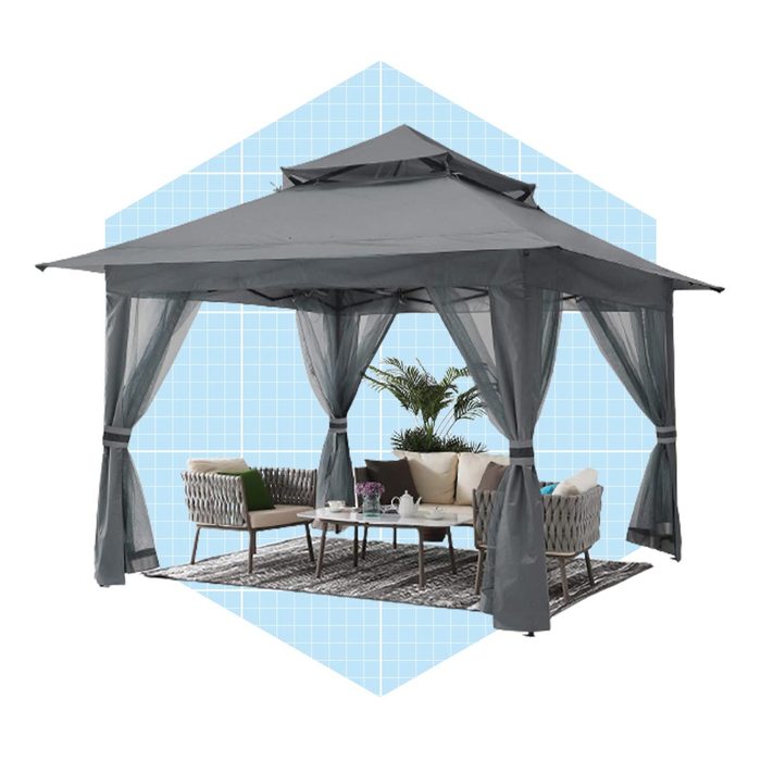 A gray gazebo shelters a seating area, featuring a table and comfortable chairs, surrounded by decorative plants, set against a light blue grid background.