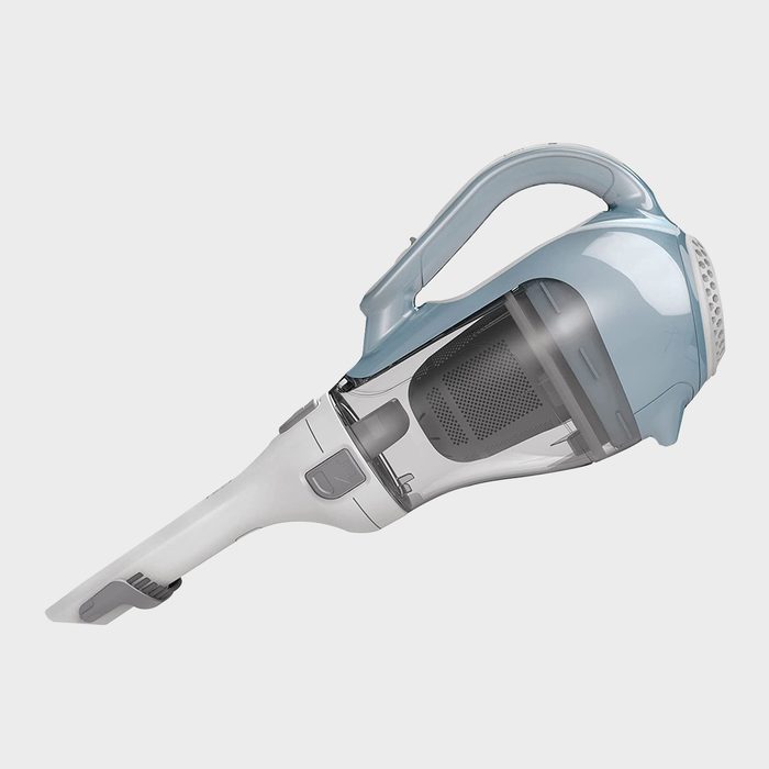 A handheld vacuum cleaner is positioned at an angle, with a transparent dustbin and a comfortable grip handle, designed for ease of use in cleaning.