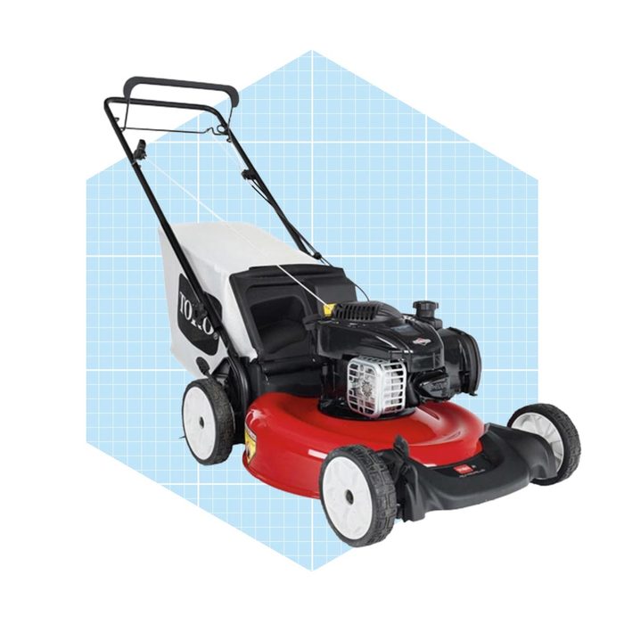A red and black lawn mower rests against a light blue geometric background, designed for cutting grass with precision in outdoor spaces.