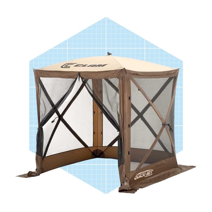 A brown tent with mesh sides stands upright, designed for outdoor use, offering shelter while allowing ventilation in a blue grid-patterned background.