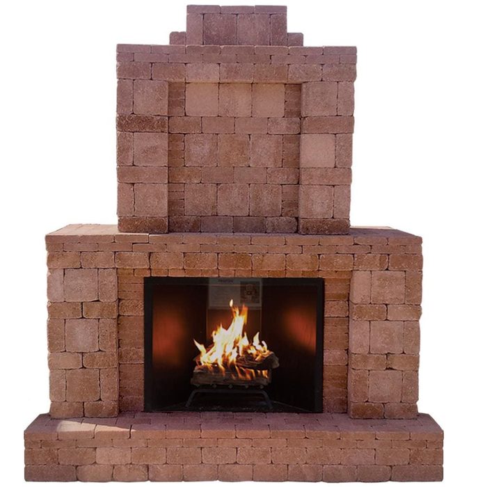 A stone fireplace displays a bright fire burning within, surrounded by neatly arranged blocks, set against a plain background, evoking a warm, inviting atmosphere.