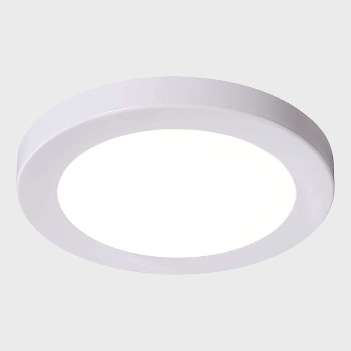 A round ceiling light illuminates a neutral background, providing bright, even light suitable for indoor spaces such as homes or offices.