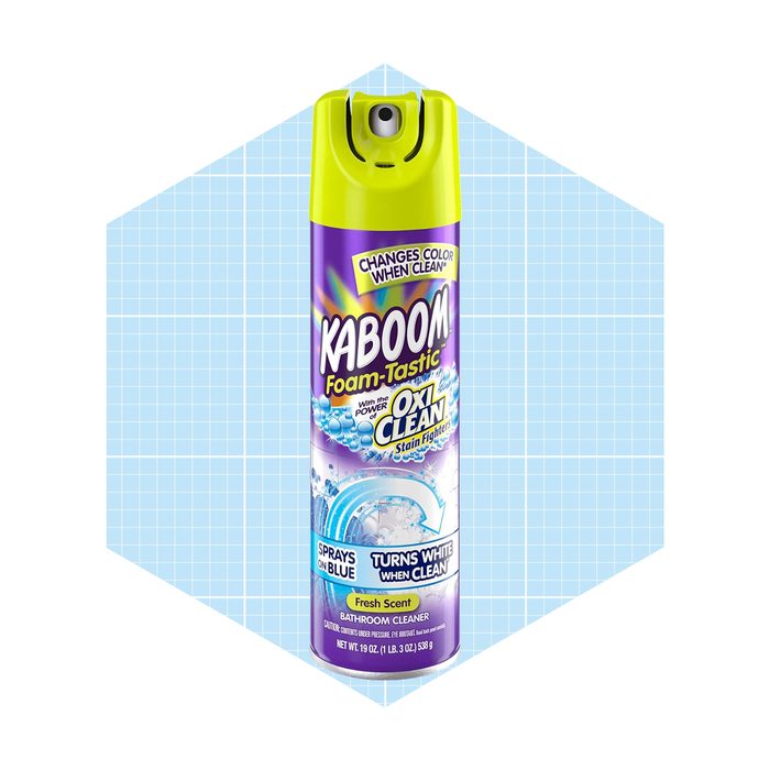A spray can of Kaboom bathroom cleaner, featuring bold colors and text. It indicates it changes color when clean, set against a light blue grid background.