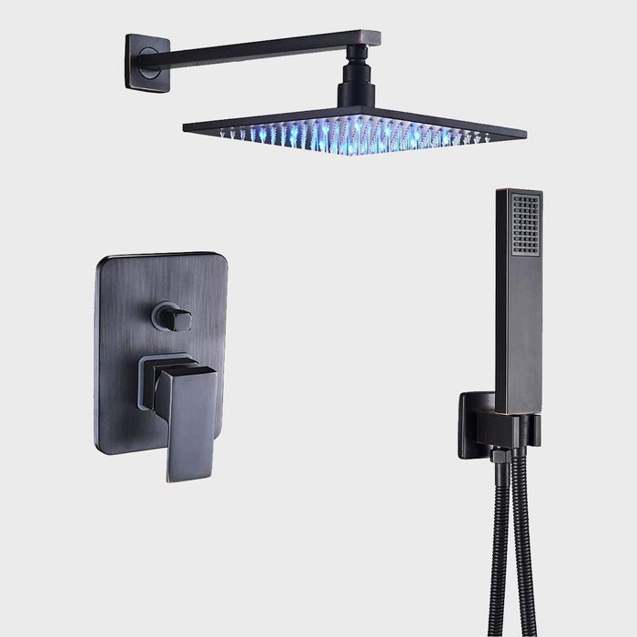 A modern shower system features a rectangular overhead showerhead with blue lights, controls on a wall plate, and a handheld shower with a flexible hose.