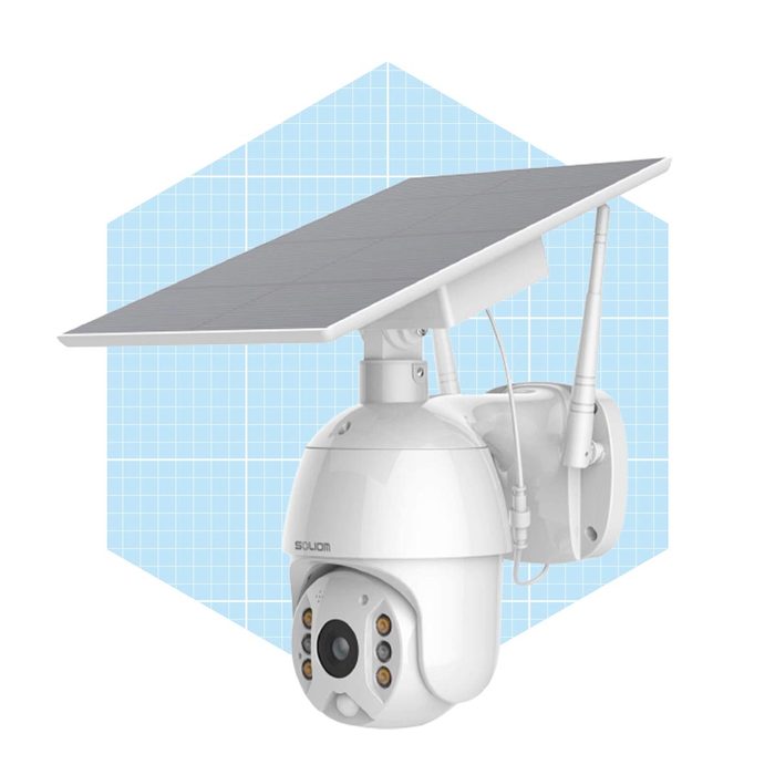 A white solar-powered security camera is mounted on a wall, capturing video while connected to an oversized solar panel, set against a light blue grid background.