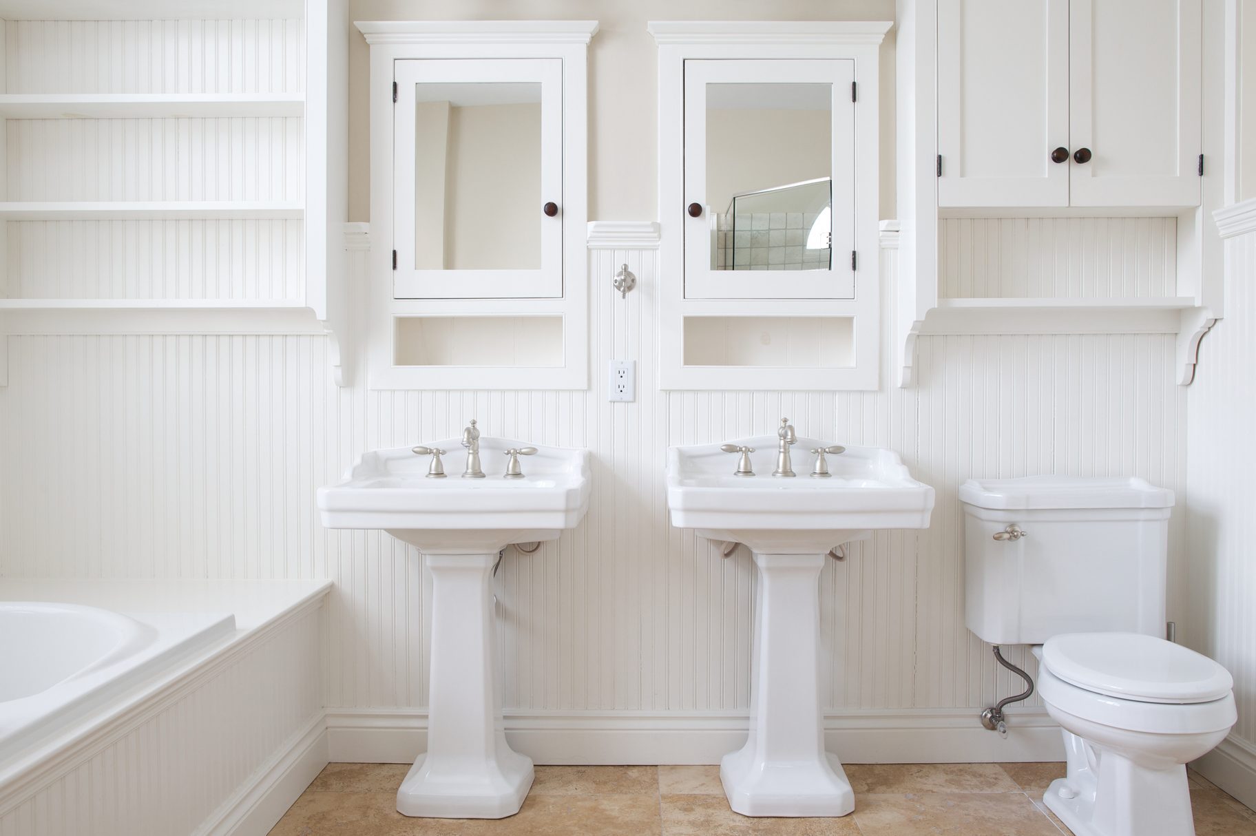 Modern and white washroom with bathtub and two mirrors