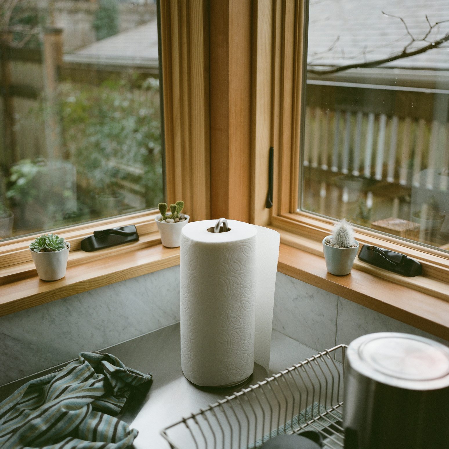 kitchen counter with natural wood trim and marble countertop