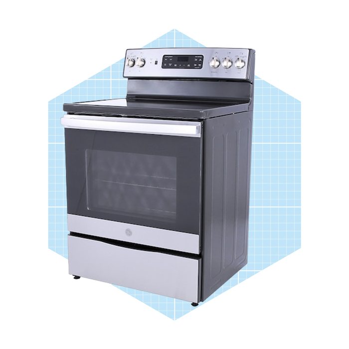 A modern stove with a glass oven door, control knobs, and a metallic finish stands against a light blue geometric background.