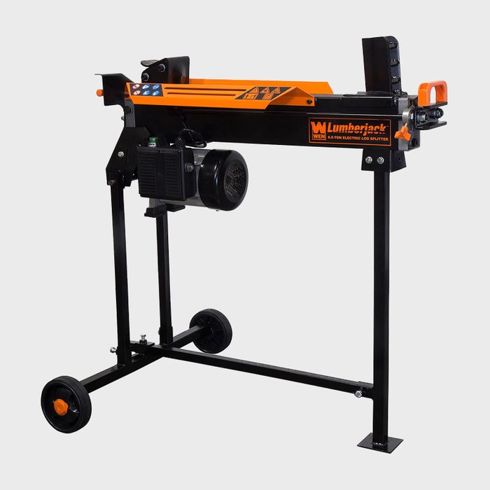 A black and orange electric log splitter stands on wheels, designed for splitting logs with a powerful motor, suitable for outdoor wood processing.