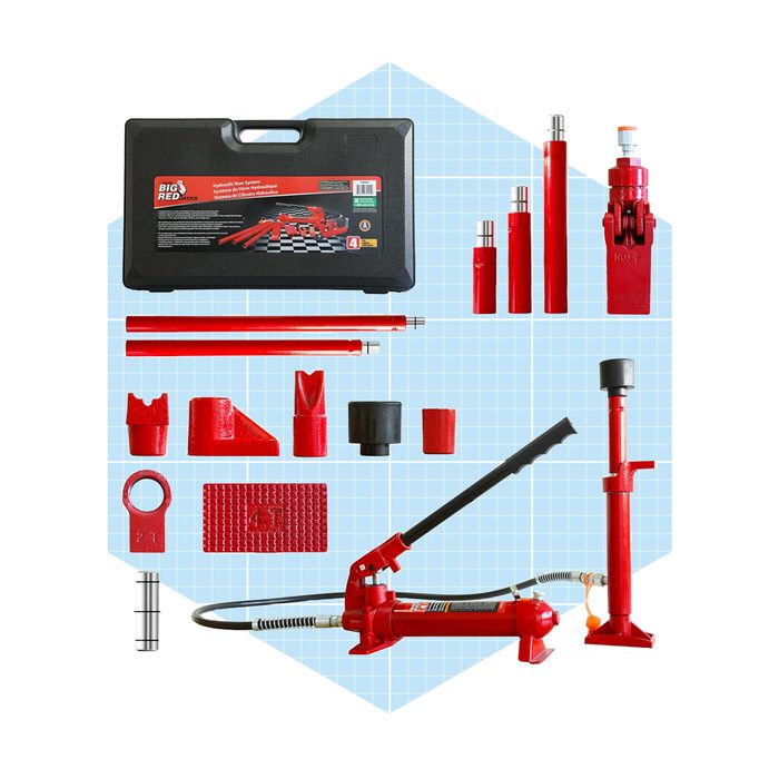 A red hydraulic jack kit arranged neatly, including various attachments, tools, and a carrying case, set against a light blue grid background.