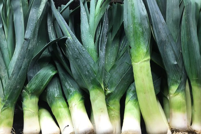 Close-Up Of Wet Leeks For Sale In Market