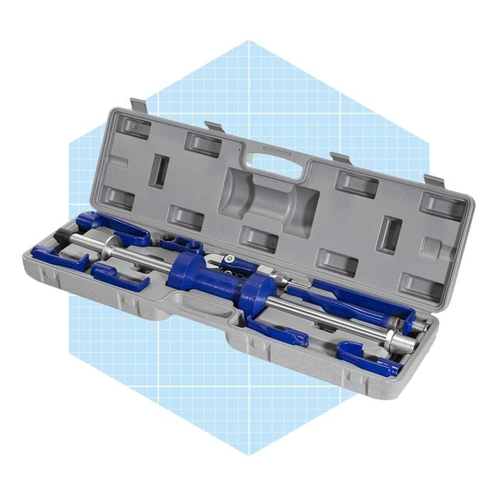 A closed gray toolbox holds blue tools inside, organized in specific slots, resting on a light blue grid-patterned background.