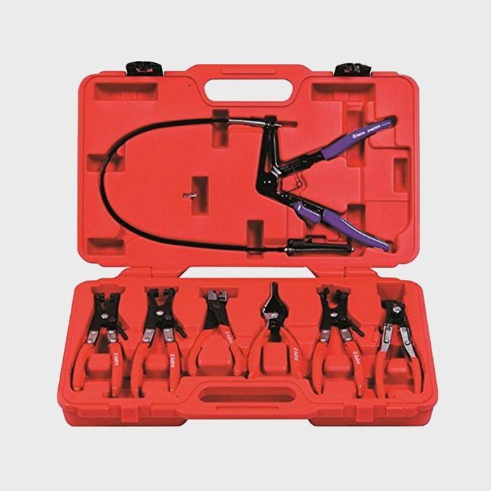 A red tool case contains various pliers and clamps, organized neatly, indicating preparation for mechanical or repair tasks in a workshop environment.