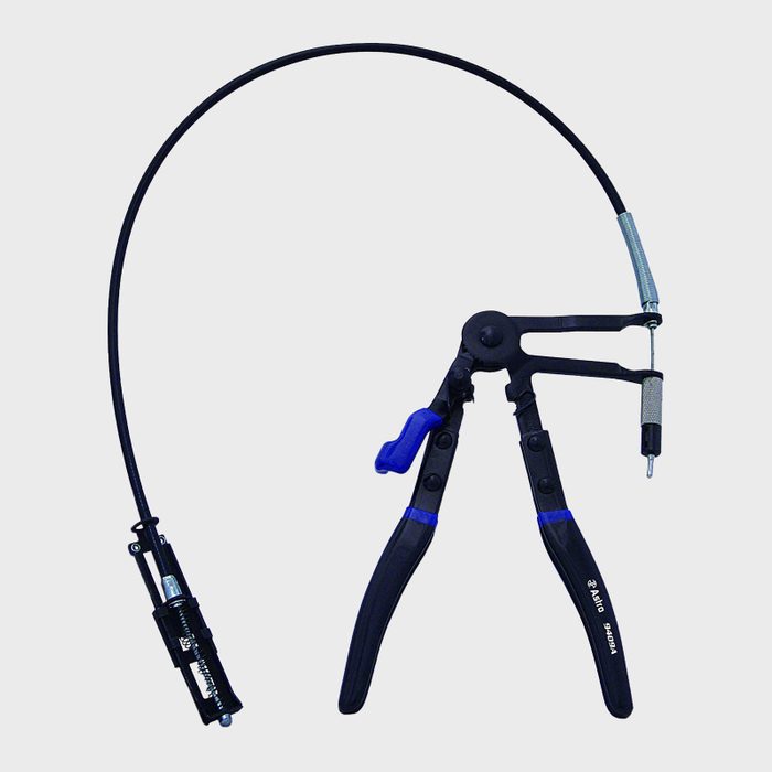 A caliper tool with adjustable arms is positioned upright, featuring a flexible cable connected to a tool tip, suitable for precise measurements in mechanical tasks.