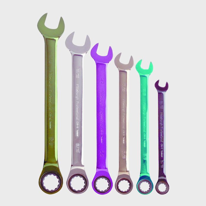 A row of six colorful wrenches varies in size. They are positioned horizontally against a plain background, showcasing different widths and shapes of their open ends.