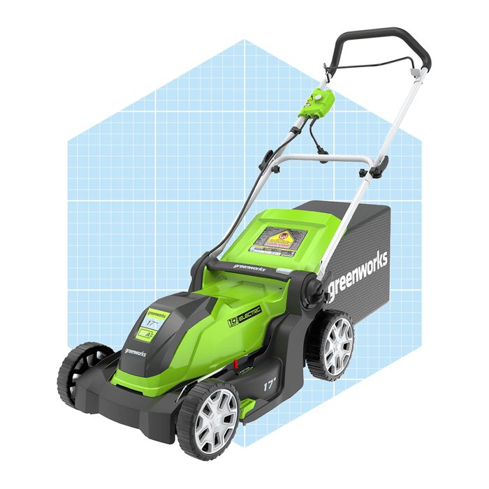 An electric lawn mower with a green and black design stands upright, showcasing its battery and features against a light blue, grid-patterned background.