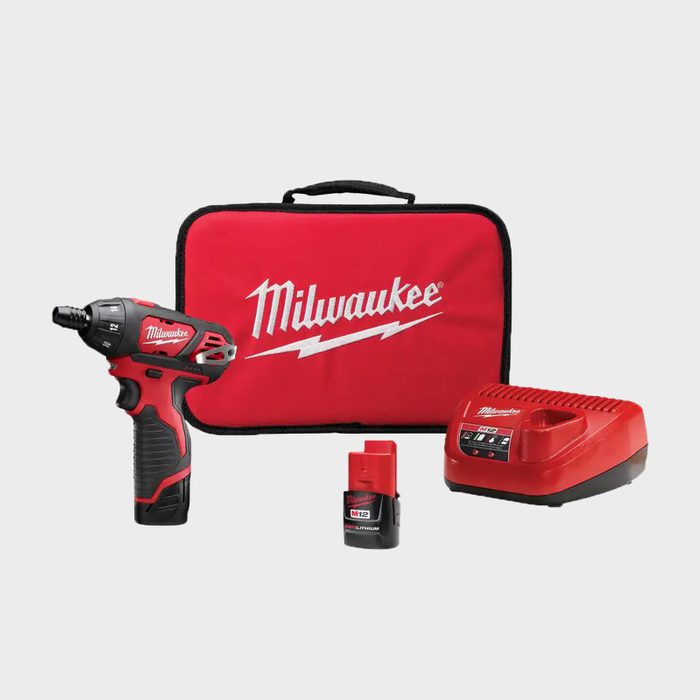 A cordless drill with a battery and charger is displayed alongside a red carrying case, all featuring the Milwaukee logo, against a plain background.
