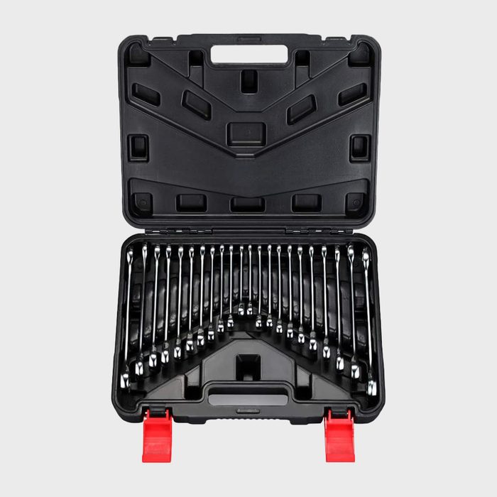 A black tool case is open, displaying neatly organized metal wrenches and sockets, with red latches visible, on a light gray background.