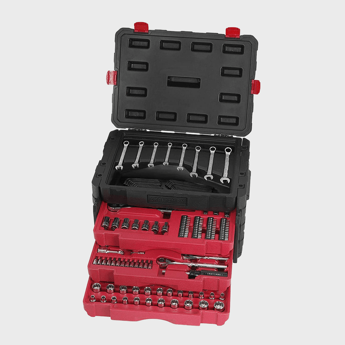 A neatly organized toolbox is open, displaying various tools layered in red and black trays, positioned against a plain background.
