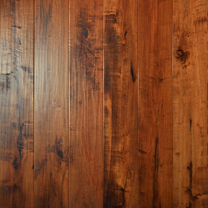 Wooden floorboards, arranged lengthwise, exhibit a rich, dark brown hue with visible grain patterns and slight variations, providing a warm and natural appearance.