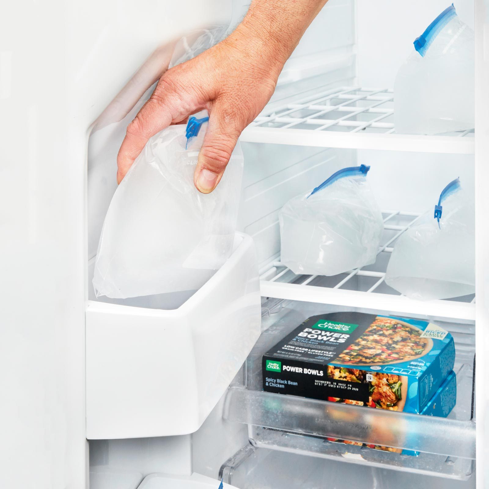 plastic bags of ice in a freezer