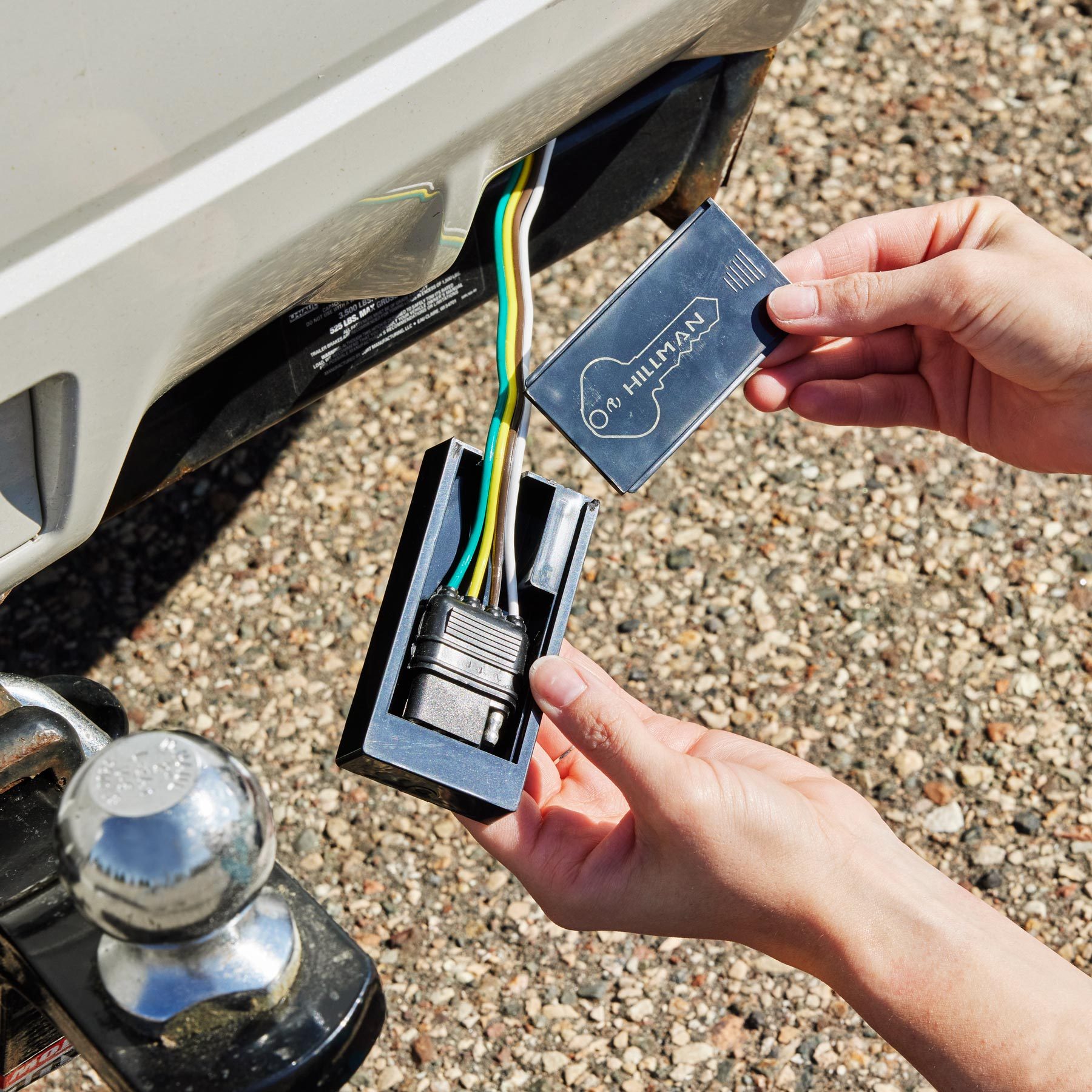 hands holding a magnet container with trailer wires inside