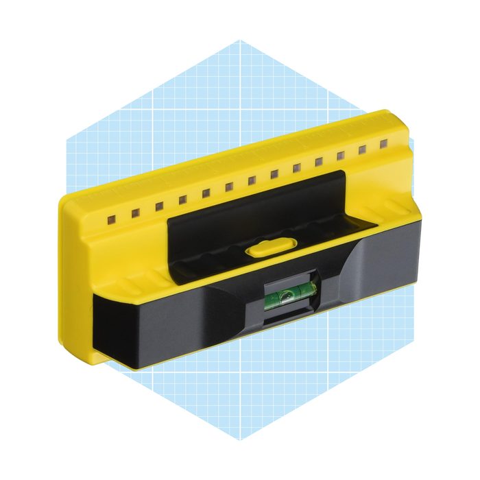 A yellow and black leveling tool is positioned with a bubble level visible, set against a light blue hexagonal background with a grid pattern.