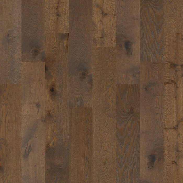 Wood flooring with various shades of brown is laid out in a parallel pattern, showcasing natural grain and texture in a well-lit, indoor setting.