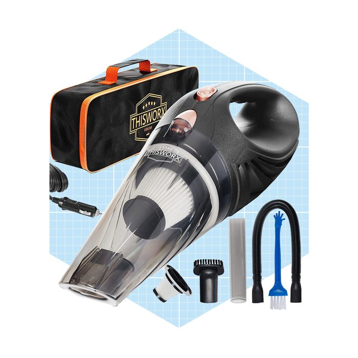 A handheld vacuum cleaner is displayed with various attachments and a carrying case, set against a light blue grid background, ready for use in cleaning tasks.