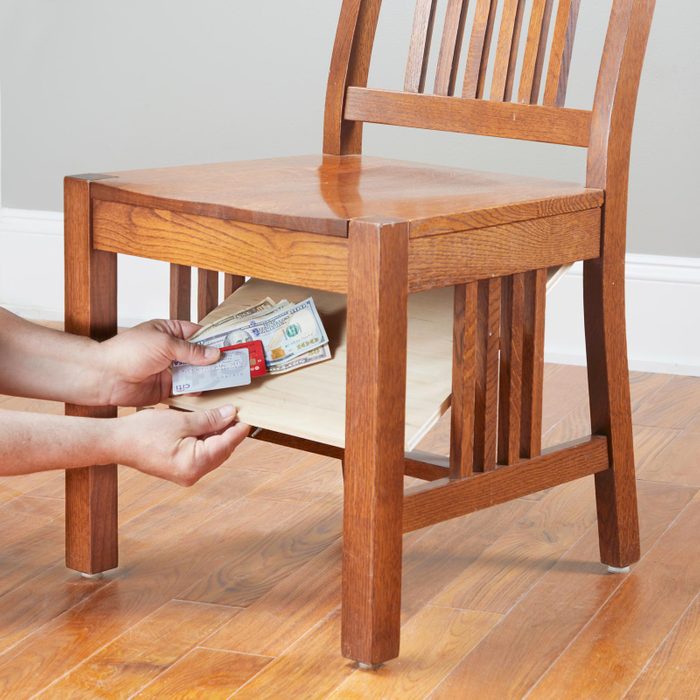 hiding money and important documents under a wooden chair