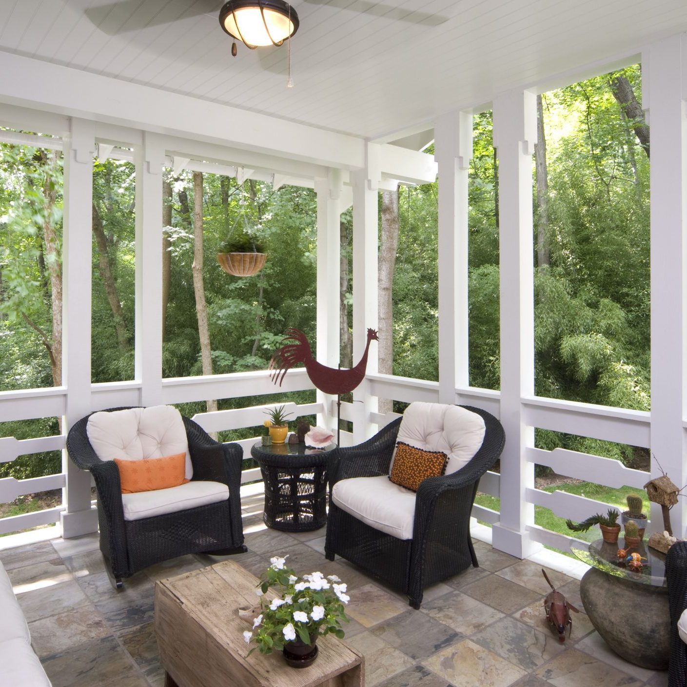 Peaceful enclosed back deck/porch with furniture