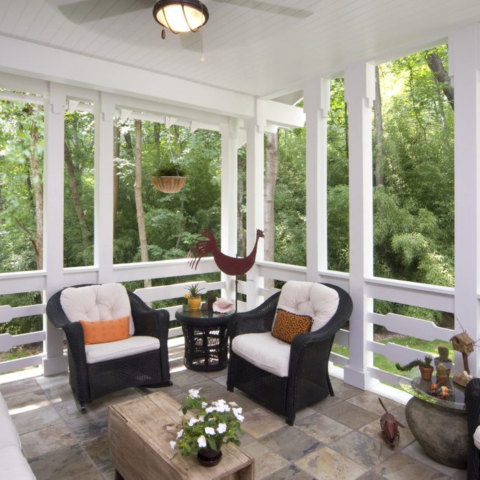 Peaceful enclosed back deck/porch with furniture