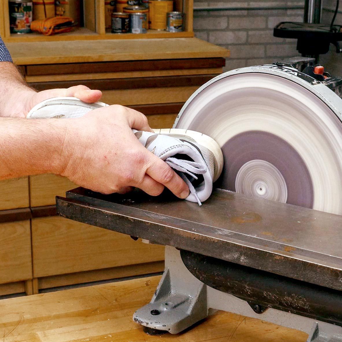 sanding the bottom of a sneaker