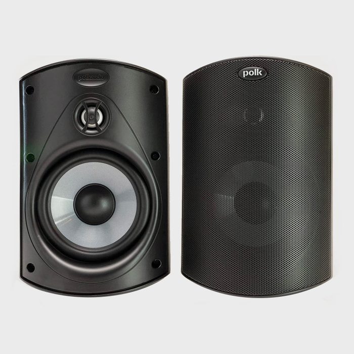 Two black speakers are displayed side by side, showcasing their audio drivers and mesh grills, highlighting their design for sound amplification in various settings.