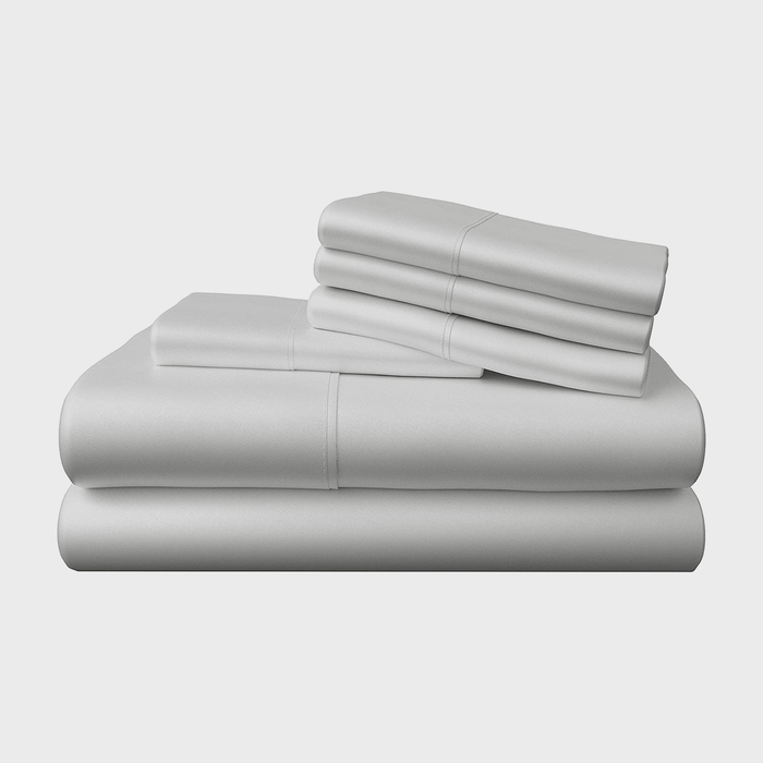 Stacked light gray sheets, neatly arranged with a folded set on top, are displayed against a white background.