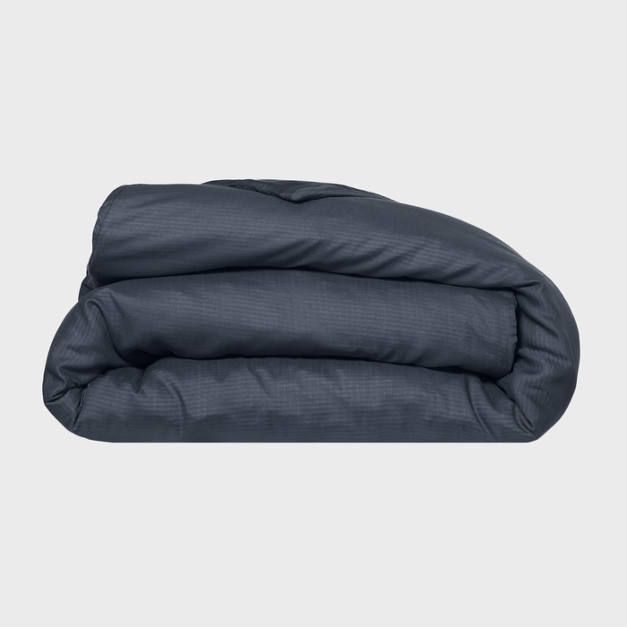 A folded, dark gray blanket rests on a light background, showcasing its soft texture and layered form, ready for use or storage.