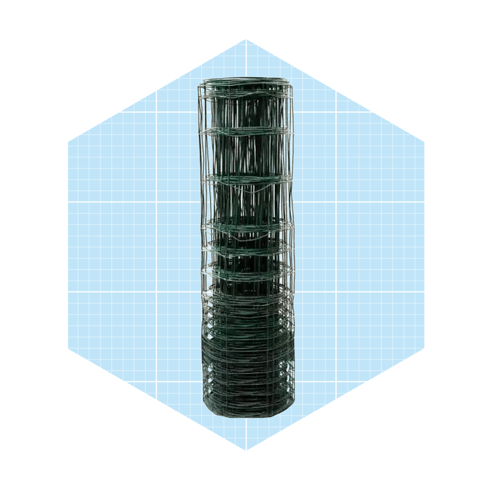 A cylindrical stack of green wire mesh is positioned upright against a light blue, grid-patterned background, suggesting organization and storage for gardening or fencing purposes.