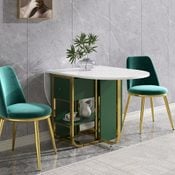 A modern, oval dining table with a white top and green accents stands between two stylish teal chairs on a polished floor, accompanied by a decorative plant.