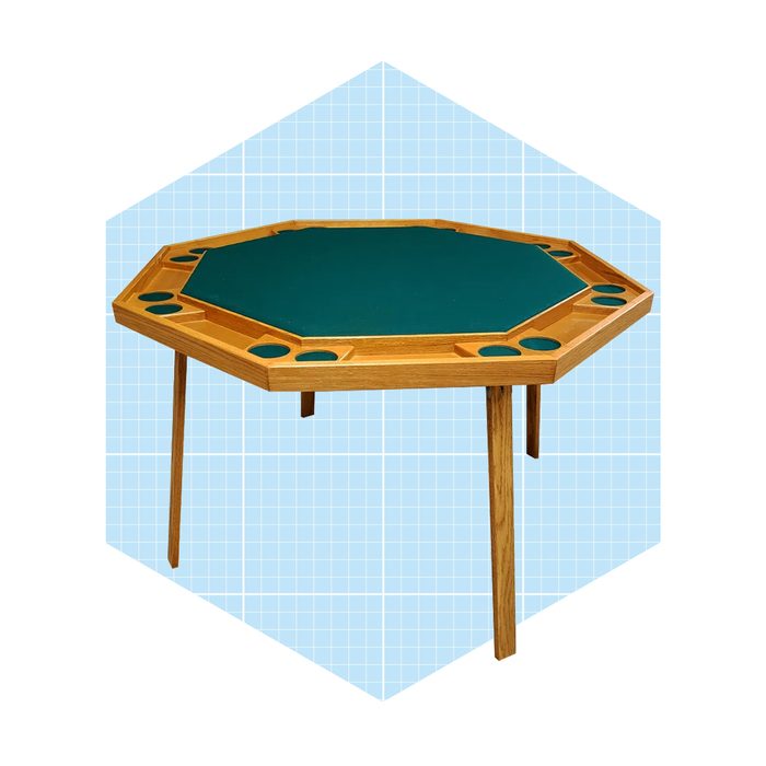 An octagonal table with a green felt surface stands on four wooden legs, featuring circular recesses around the edge, set against a light blue grid background.