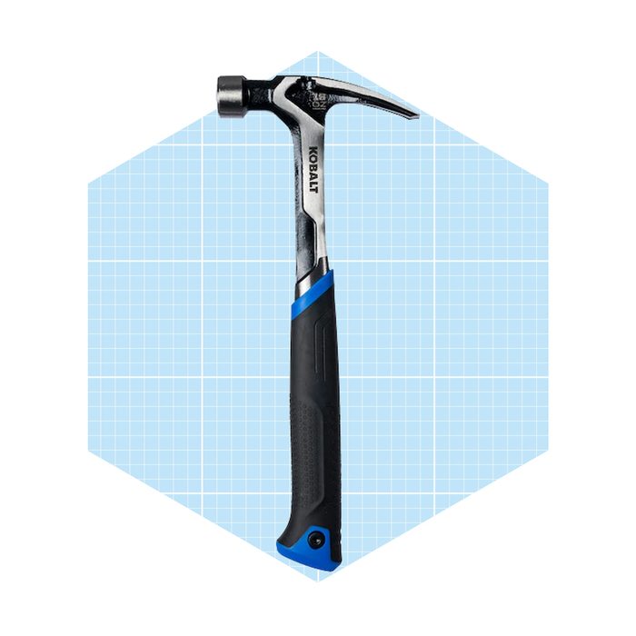 A hammer stands upright, showcasing its metal head and curved claw, against a light blue grid background, emphasizing its design and function.