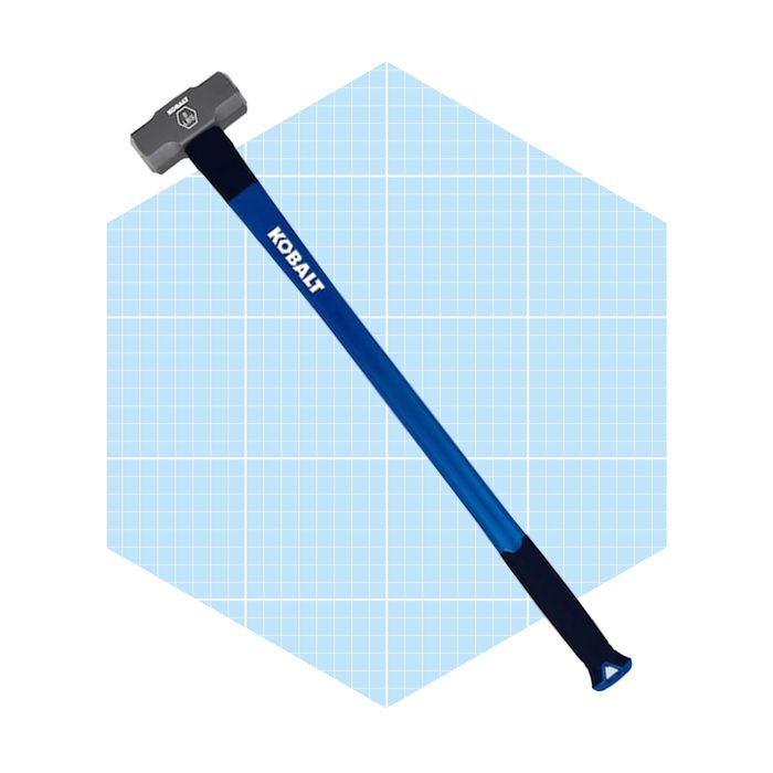 A blue-handled hammer rests against a light blue grid background, suggesting a tool used for striking or breaking materials in construction or repair work.