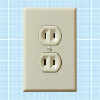 A beige electrical outlet is mounted on a light blue grid-patterned wall, showcasing two receptacles for plugging in devices.