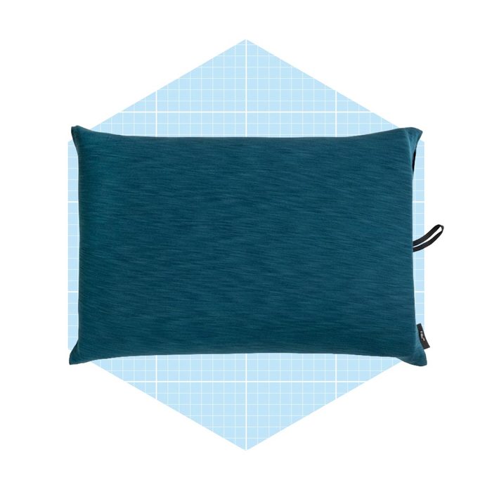 A blue decorative pillow rests on a light blue grid-patterned background, showcasing its simple, modern design and emphasizing comfort and style.