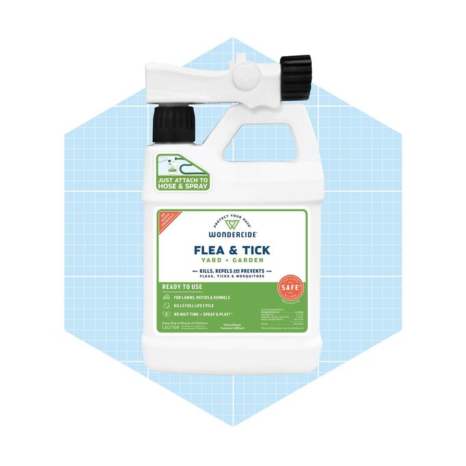 A spray bottle labeled "Wondercide Flea & Tick Yard & Garden" sits against a light blue grid background, indicating it's ready to use against pests.