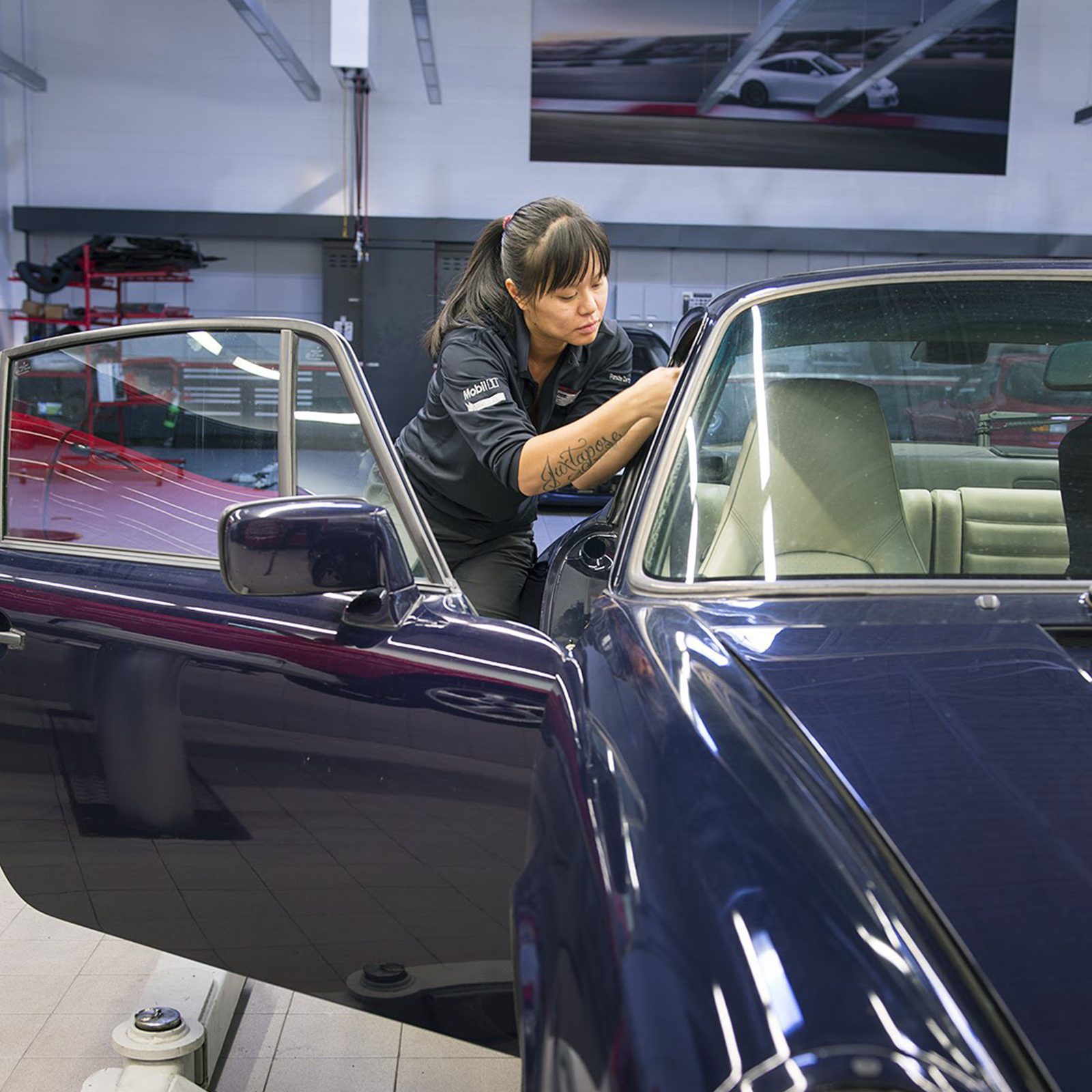 Nhu Nguyen working on restoring a car