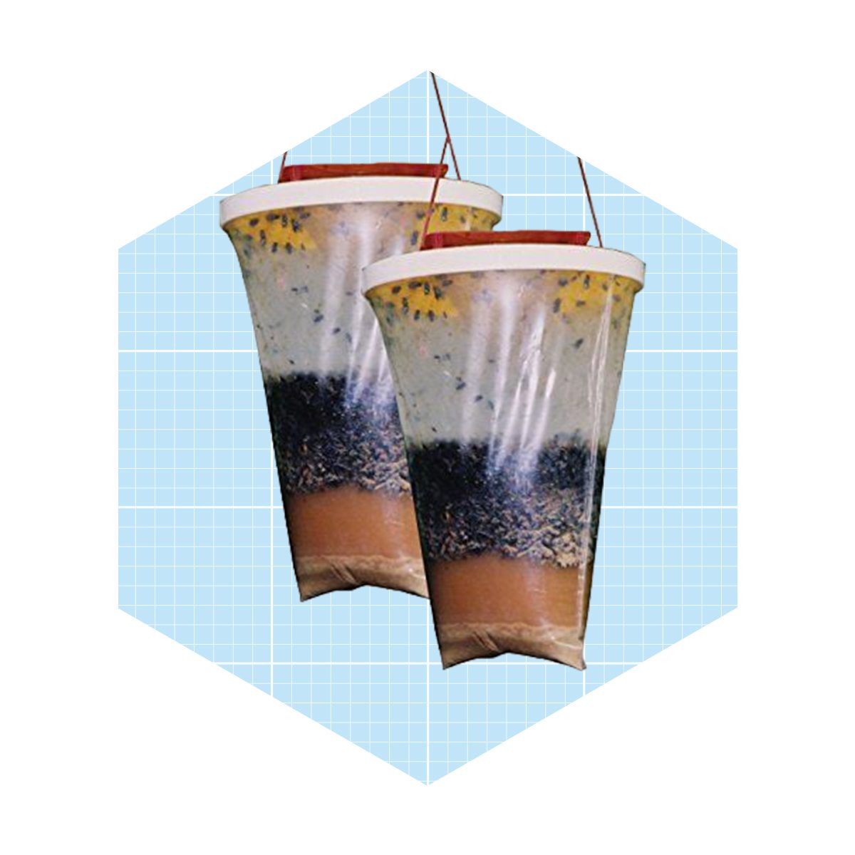 Two transparent bags filled with layered colorful substances hang against a light blue grid background. The contents include soil, water, and organic materials.