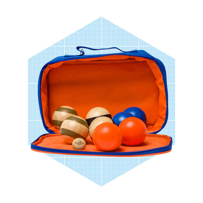 A blue zippered bag opens to reveal various colorful balls, including solid and striped designs, against an orange interior, set on a light blue grid background.